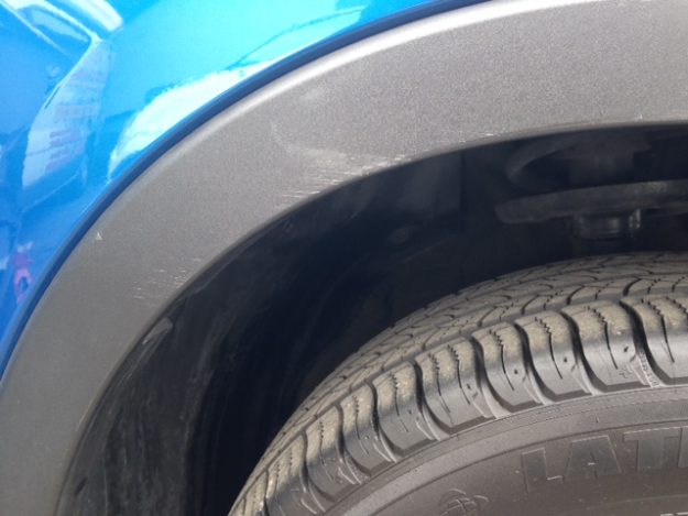 scratched wheel arch